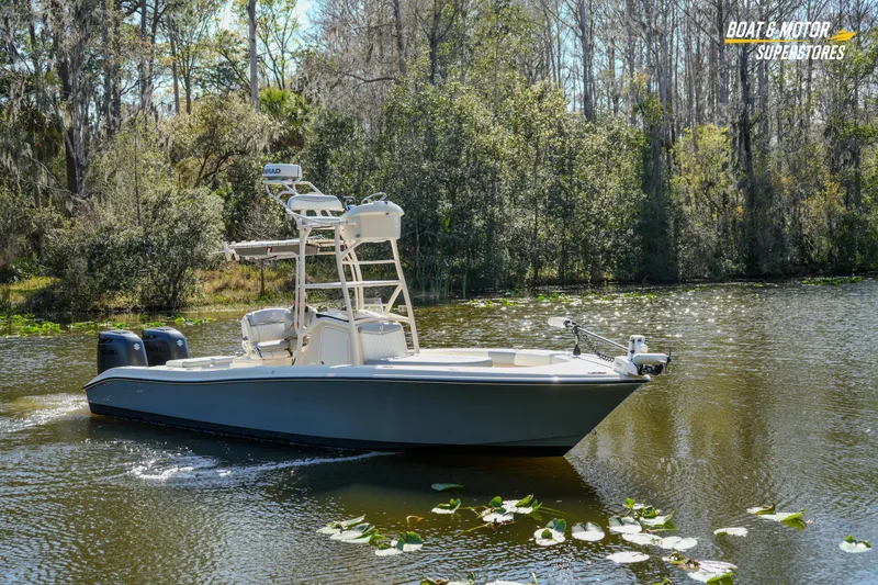 Slide: The Image of 2016 Young 27 boat cruising on a serene lake surrounded by lush trees. - 26