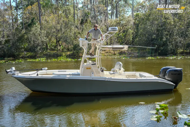 Slide: The Image of 2016 Young 27 boat on a calm river with lush forest background. - 3