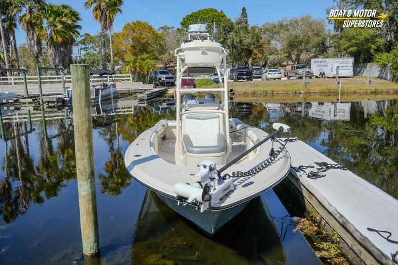 Slide: The Image of 2016 Young 27 boat docked at marina with palm trees and clear sky. - 5