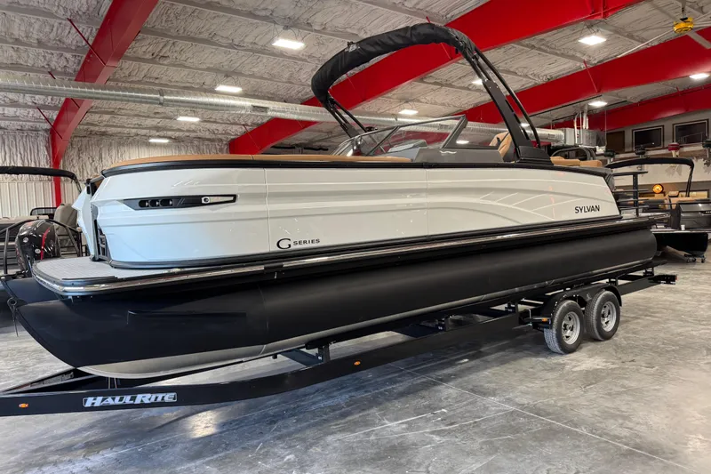 The Image of 2026 Sylvan G5 pontoon boat on trailer in indoor showroom. - 1