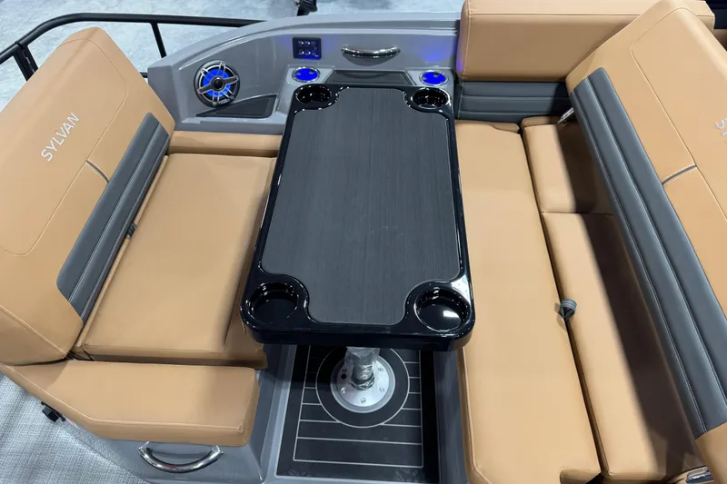 Slide: The Image of Luxurious seating area on 2026 Sylvan G5 boat with tan cushions and sleek black table. - 14