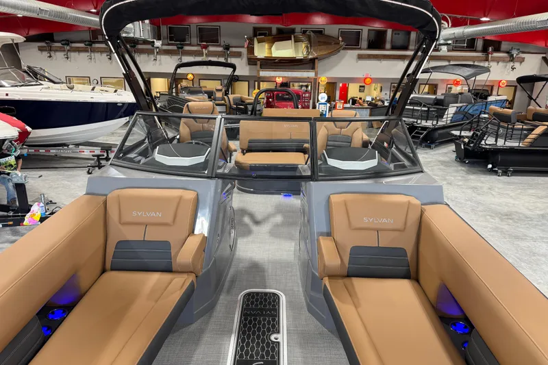 Slide: The Image of 2026 Sylvan G5 boat interior with tan seating in showroom. - 18