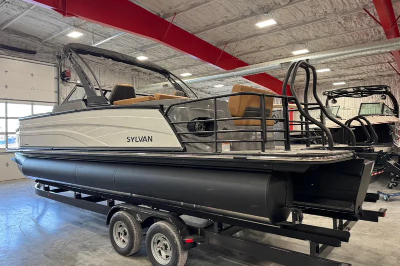Slide: The Image of 2026 Sylvan G5 pontoon boat on trailer in indoor showroom. - 5