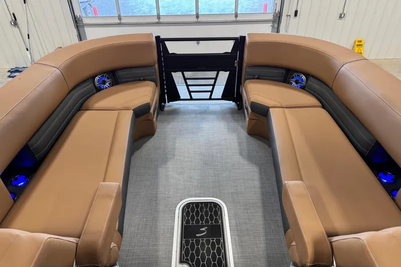 Slide: The Image of Luxurious interior of 2026 Sylvan G5 boat with tan seating and blue LED lights. - 9