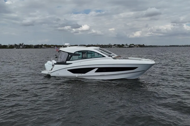 The Image of 2025 Beneteau Gran Turismo 32 yacht cruising on a calm, cloudy day. - 0