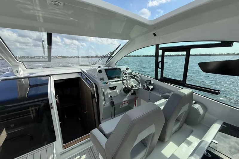 Slide: The Image of Interior view of 2025 Beneteau Gran Turismo 32 yacht cockpit with modern controls. - 13