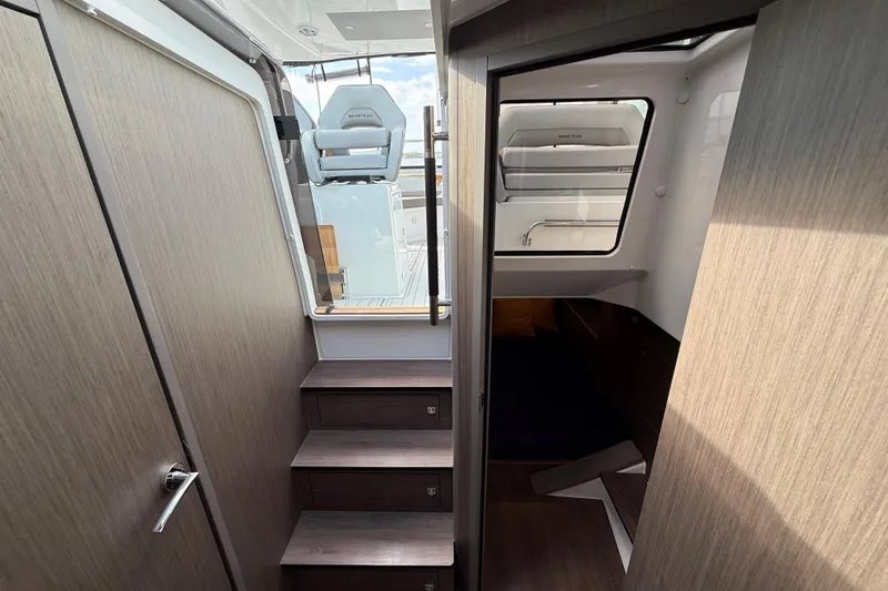 Slide: The Image of Interior view of 2025 Beneteau Gran Turismo 32 yacht, featuring modern stairs and seating. - 17
