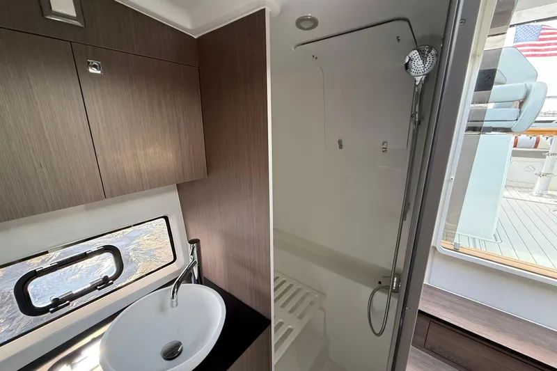 Slide: The Image of Modern bathroom interior of 2025 Beneteau Gran Turismo 32 yacht, featuring sleek sink and shower. - 18