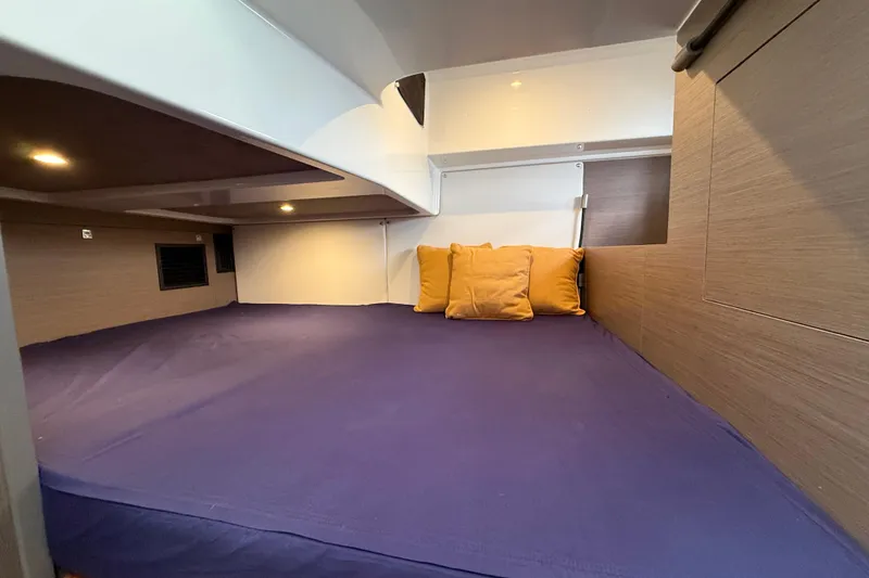 Slide: The Image of Cozy cabin interior of 2025 Beneteau Gran Turismo 32 with blue bedding and cushions. - 20