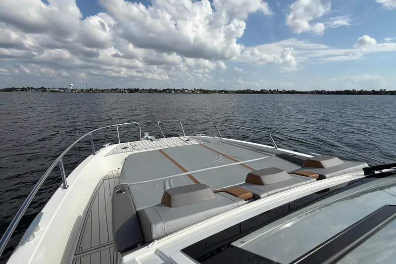 Slide: The Image of 2025 Beneteau Gran Turismo 32 yacht with spacious deck, cruising on calm waters under a cloudy sky. - 22