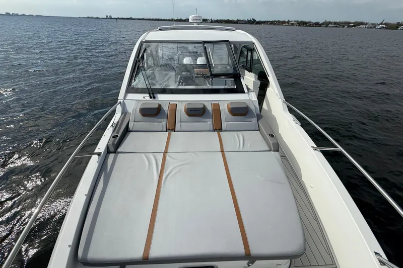 Slide: The Image of 2025 Beneteau Gran Turismo 32 yacht with spacious sunbathing deck on open water. - 24