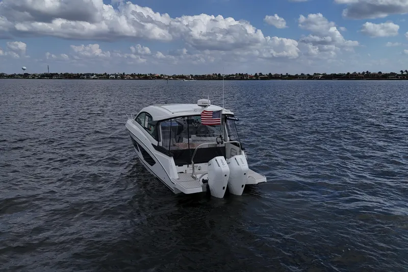 Slide: The Image of 2025 Beneteau Gran Turismo 32 yacht on open water under a cloudy sky. - 3
