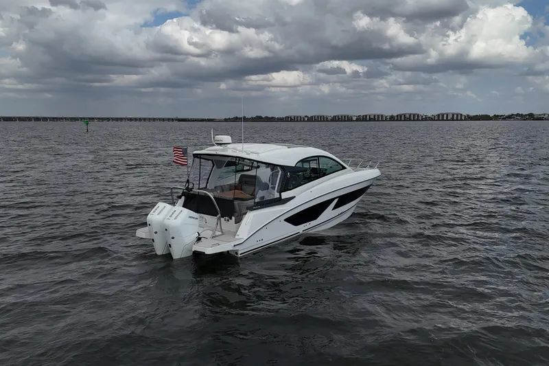 Slide: The Image of 2025 Beneteau Gran Turismo 32 yacht on open water under cloudy sky. - 4