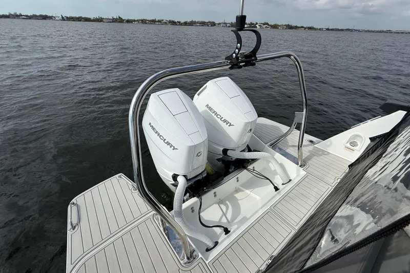 Slide: The Image of 2025 Beneteau Gran Turismo 32 with dual Mercury outboard engines on water. - 5