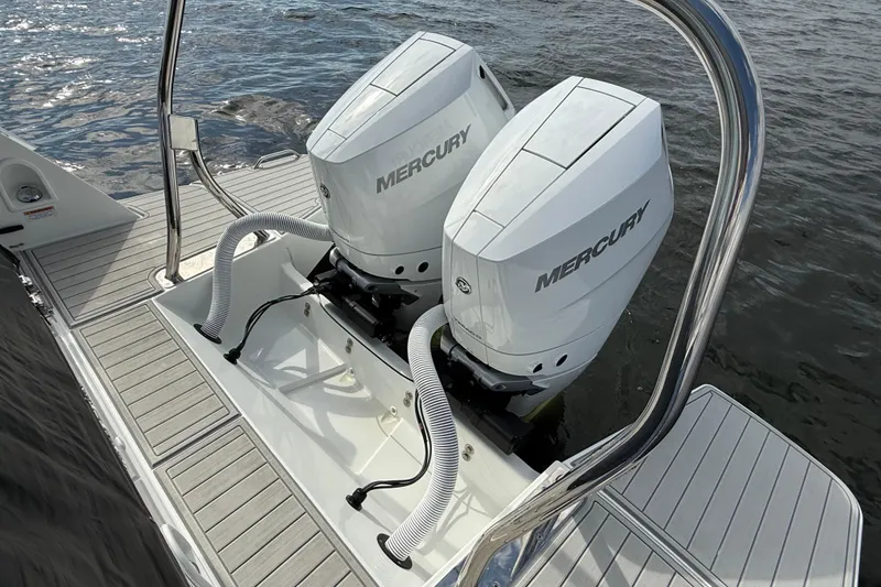 Slide: The Image of 2025 Beneteau Gran Turismo 32 with dual Mercury outboard engines on water. - 6