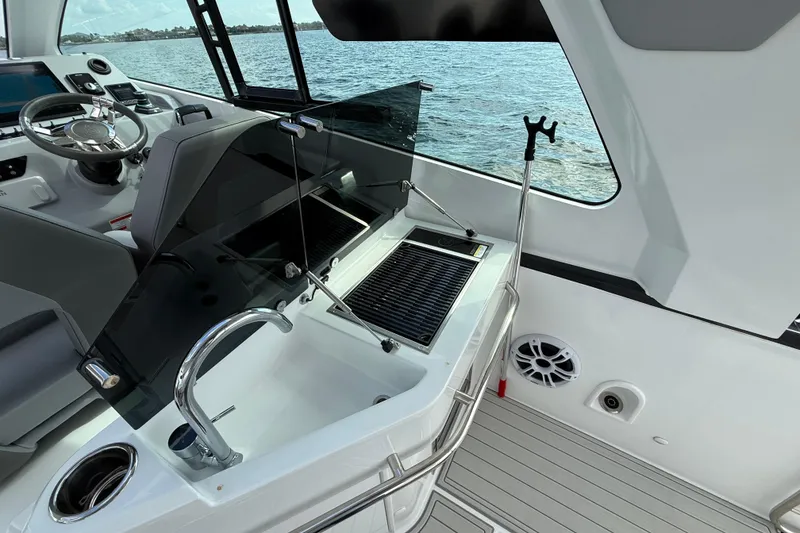 Slide: The Image of 2025 Beneteau Gran Turismo 32 yacht interior with steering wheel and kitchenette. - 9