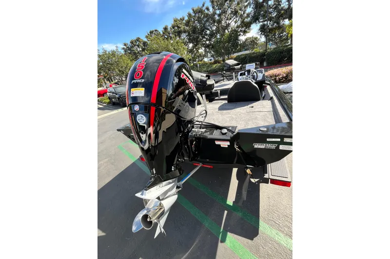 Slide: The Image of 2026 Tracker Pro Team 195 boat with powerful outboard motor in a sunny outdoor setting. - 5