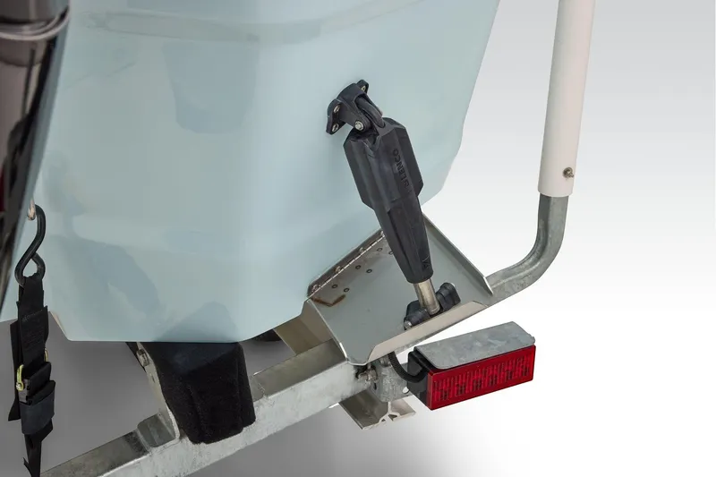 Slide: The Image of 2026 Mako 24 APEX boat trailer detail with stabilizer and red reflector. - 52
