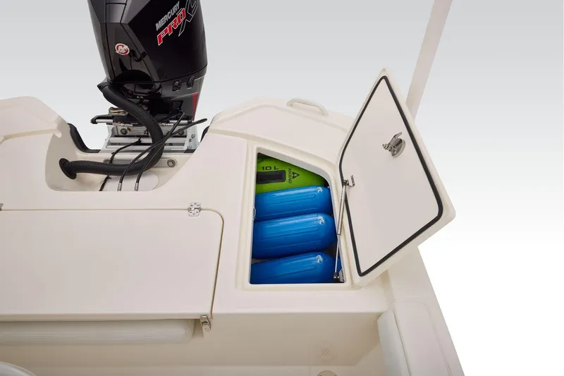 Slide: The Image of 2026 Mako 24 APEX boat storage compartment with blue fenders and Mercury Pro XS engine. - 45