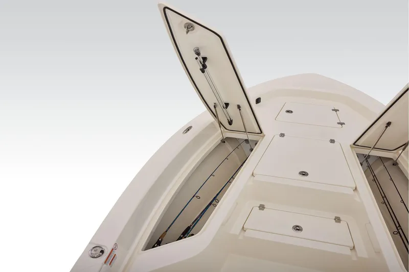 Slide: The Image of 2026 Mako 24 APEX boat with open storage compartments on deck. - 15