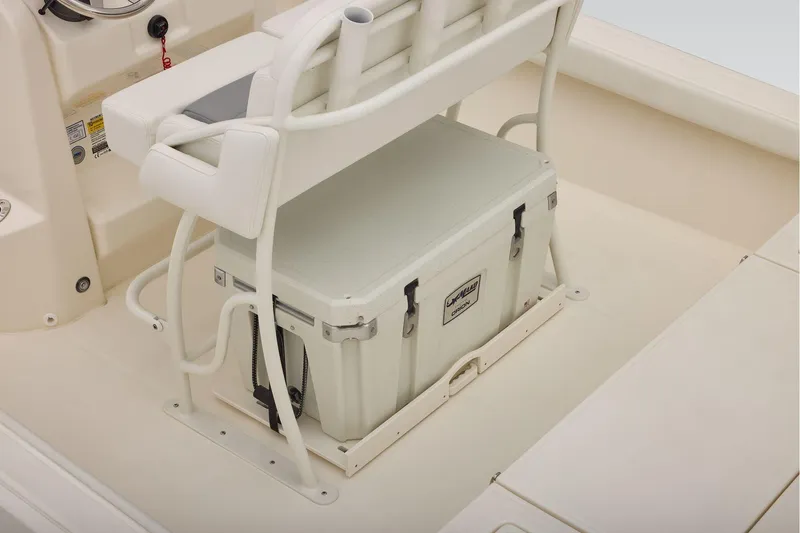 Slide: The Image of 2026 Mako 24 APEX boat interior with cushioned seating and storage cooler. - 40