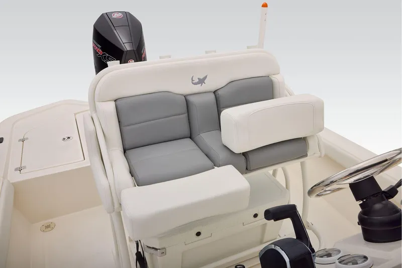 Slide: The Image of 2026 Mako 24 APEX boat interior with cushioned seating and steering wheel. - 36