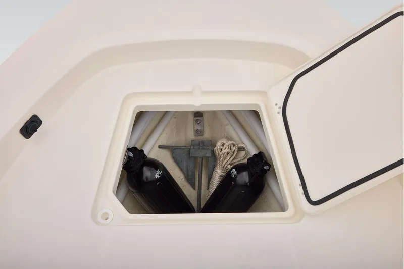 Slide: The Image of Storage compartment of 2026 Mako 24 APEX boat with anchor and fenders. - 12