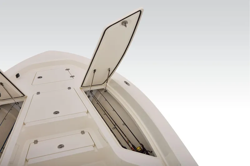 Slide: The Image of 2026 Mako 24 APEX boat storage compartments with open hatches, showcasing ample space. - 16