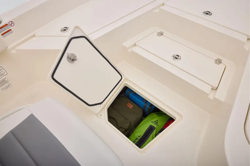 Slide: The Image of Storage compartment on 2026 Mako 24 APEX boat, featuring secure hatch and organized gear. - 17