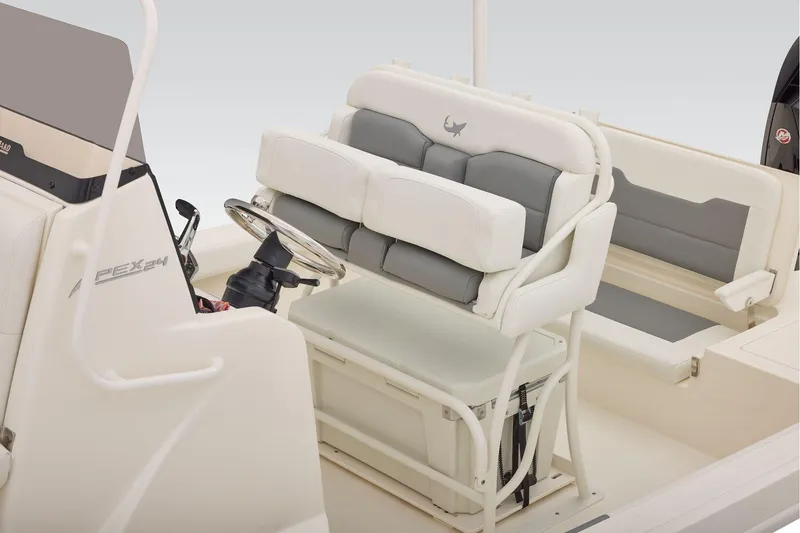 Slide: The Image of 2026 Mako 24 APEX boat interior with cushioned seating and steering console. - 37