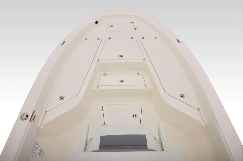 Slide: The Image of 2026 Mako 24 APEX boat deck with storage compartments and seating. - 11