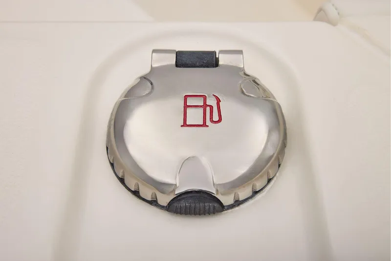 Slide: The Image of Fuel cap of 2026 Mako 24 APEX boat, featuring a metallic design. - 47