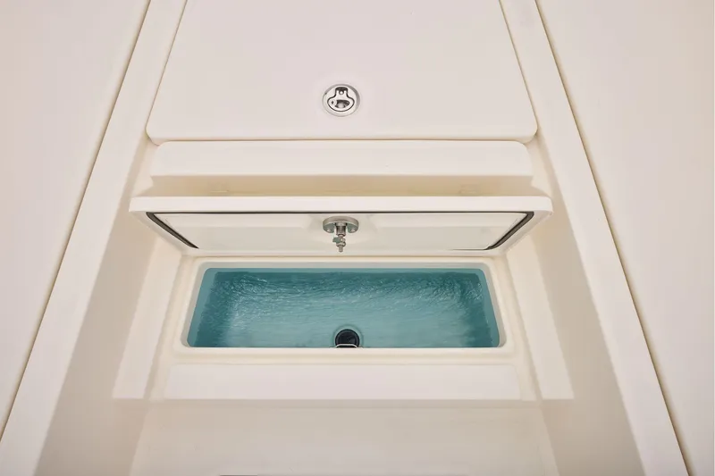 Slide: The Image of Livewell compartment on 2026 Mako 24 APEX boat, featuring a sleek design. - 18