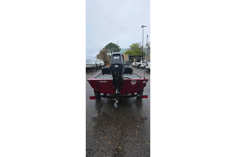 Slide: The Image of 2026 Tracker Bass Tracker Classic XL boat with 50 HP motor, parked outdoors. - 2