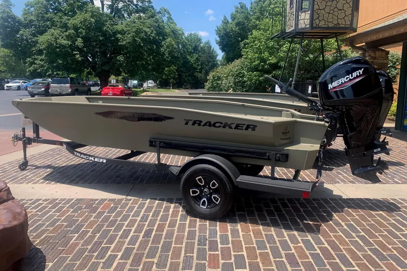The Image of 2026 Tracker Grizzly 1650 T Prairie Wings Edition boat on trailer, parked outdoors. - 0