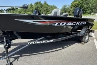 The Image of 2026 Tracker Super Guide V-16 T boat on trailer in sunny outdoor setting. - 0