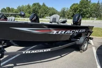 Slide: The Image of 2026 Tracker Super Guide V-16 T boat on trailer, parked outdoors. - 2