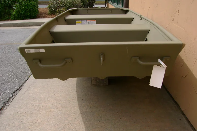 Slide: The Image of 2026 Tracker Grizzly 12 Jon boat in olive green, parked on concrete. - 3