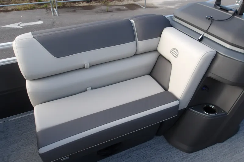 Slide: The Image of 2026 Sun Tracker Fishin' Barge 20 DLX boat seating, featuring gray and white upholstery. - 15