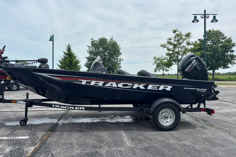 The Image of 2026 Tracker Super Guide V-16 SC boat on trailer in parking lot. - 0