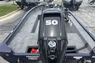 Slide: The Image of 2026 Tracker Super Guide V-16 SC boat with Mercury 50 engine, parked outdoors. - 4