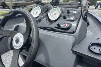 Slide: The Image of 2026 Tracker Super Guide V-16 SC boat dashboard with steering wheel and gauges. - 3