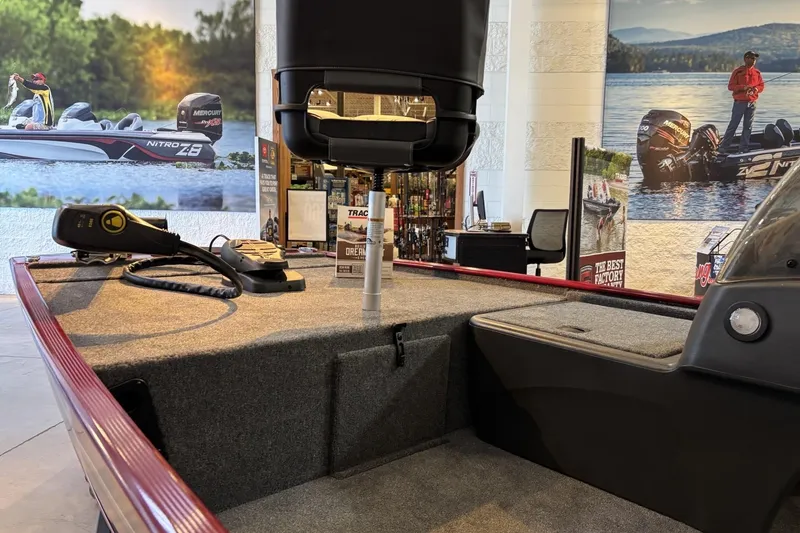 Slide: The Image of 2026 Tracker Bass Tracker Classic XL boat interior with fishing equipment and showroom display. - 3