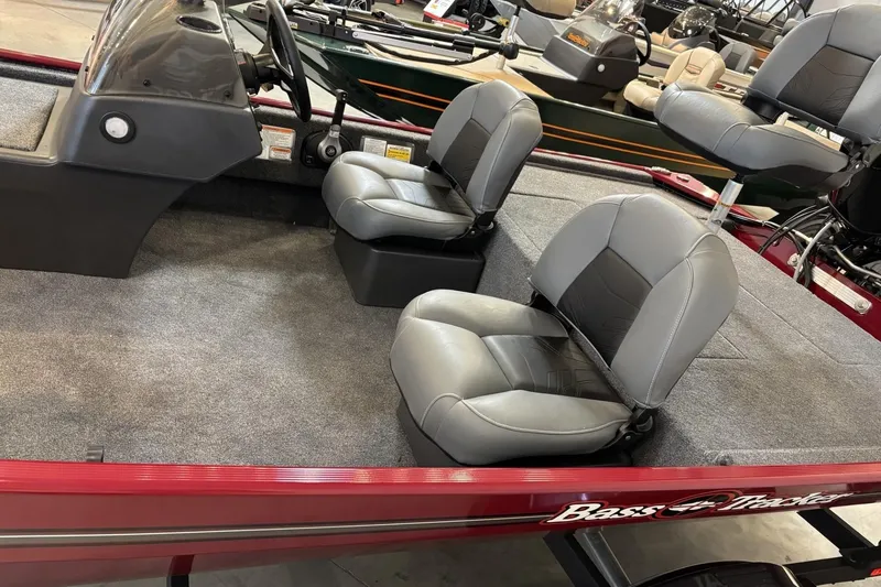 Slide: The Image of 2026 Tracker Bass Tracker Classic XL boat interior with gray seating and steering console. - 4