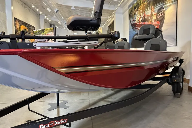 The Image of 2026 Tracker Bass Tracker Classic XL boat in showroom, featuring sleek red design and comfortable seating. - 0
