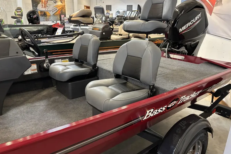 Slide: The Image of 2026 Tracker Bass Tracker Classic XL boat with Mercury engine, featuring comfortable seating. - 2