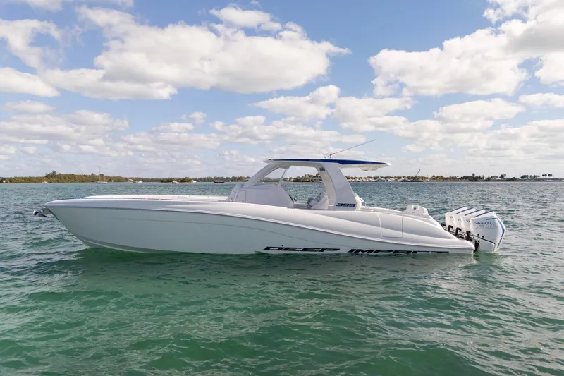 Slide: The Image of 2026 Deep Impact 399 Sport boat on calm water under a partly cloudy sky. - 5