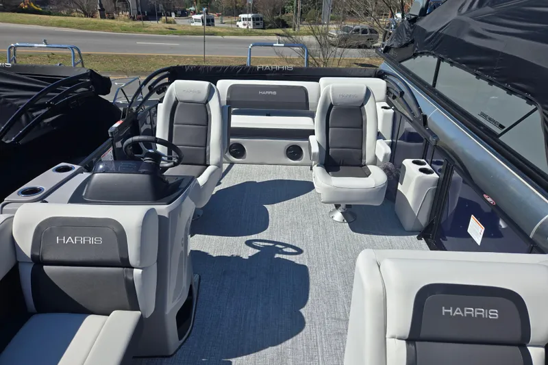 Slide: The Image of 2026 Harris Cruiser 210 SLDH pontoon boat interior with plush seating and steering console. - 6