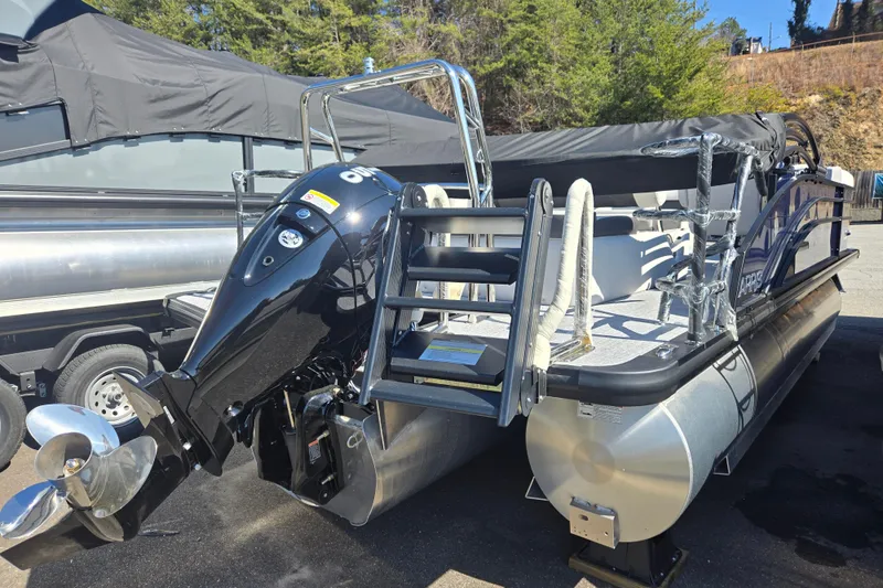 Slide: The Image of 2026 Harris Cruiser 210 SLDH pontoon boat with outboard motor, docked outdoors. - 9