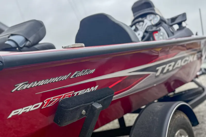 Slide: The Image of 2023 Tracker Pro Team 175 TXW Tournament Edition boat, red exterior, close-up view. - 10